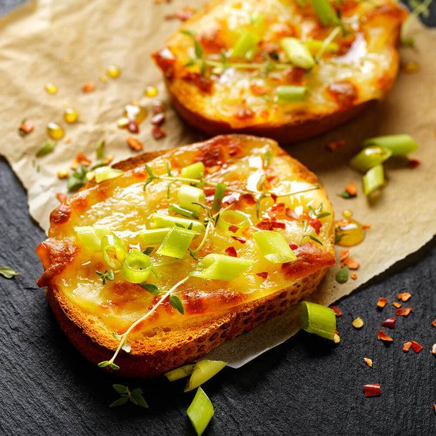 High Quality Organics Express Red Chili Pepper over cheesy toast and green onions